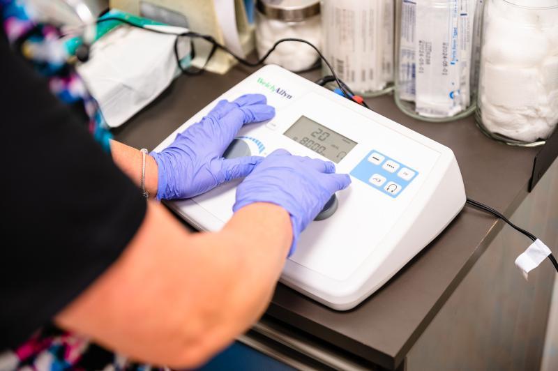 gloved hands using a medical device