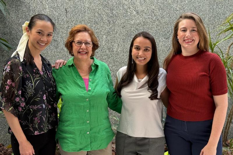 four women medical professionals smiling