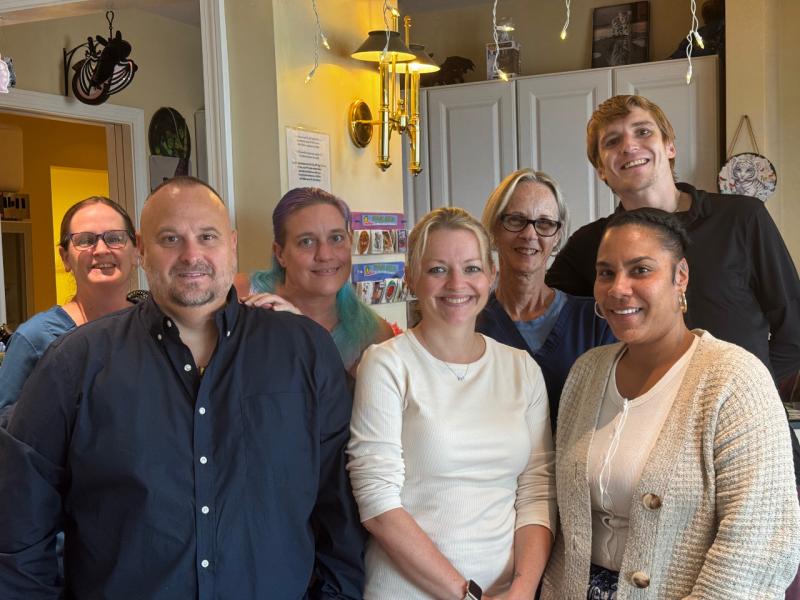 a group of people in a kitchen smiling